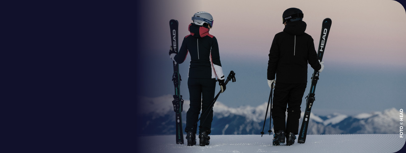 Two skiers overlooking the mountains